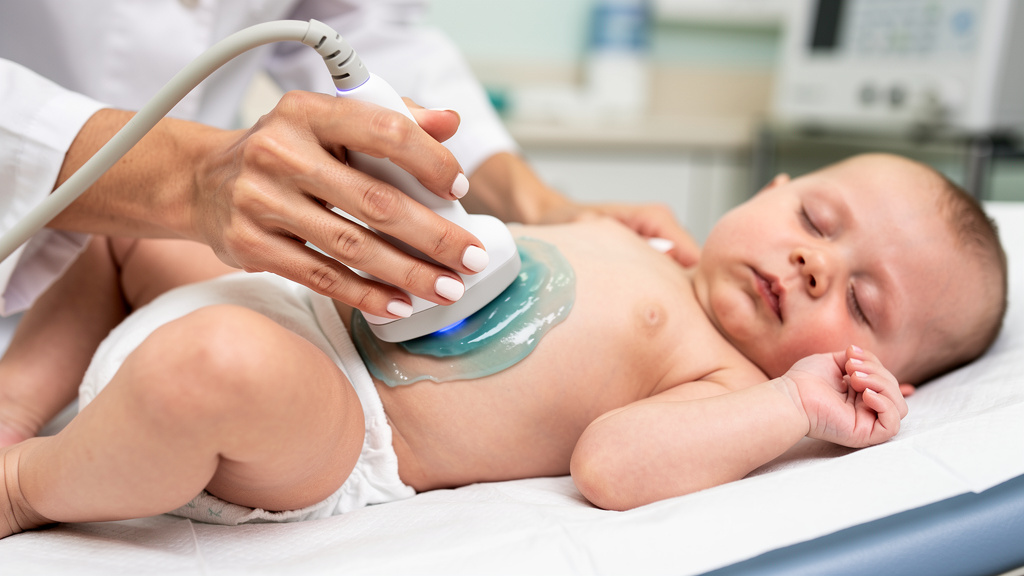 Ultrasound scan being performed on infant for hydronephrosis diagnosis